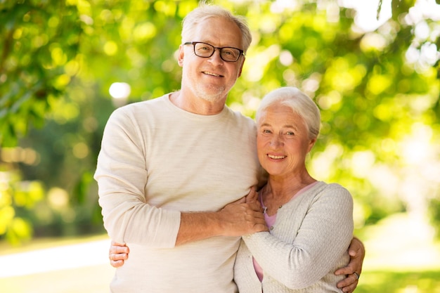 old age love and people concept happy senior couple hugging at summer park