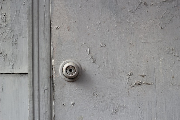 Old battered wooden door handle and lock