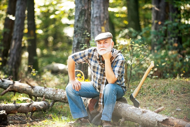 Old bearded man in forest Fashion portrait man Aged funny forester Woodman in forest Old bearded man