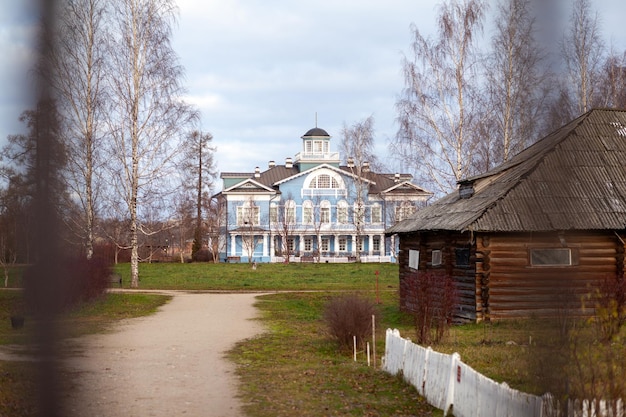 An old beautiful mansion with a wooden veranda, built in the 19th century. A big old house