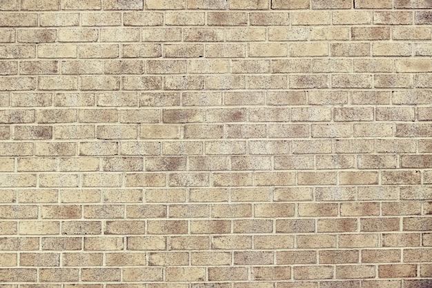 Old beige brick wall background texture