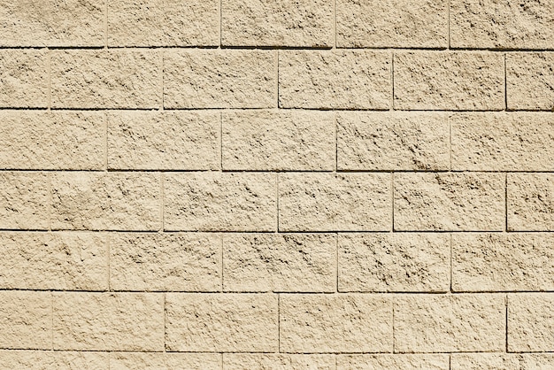 Old beige stone wall background texture