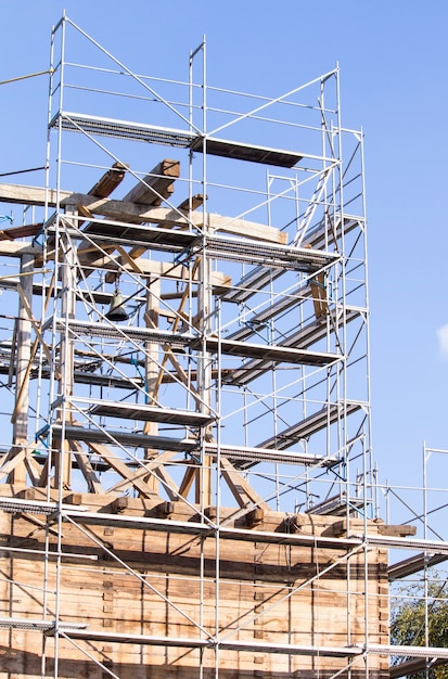 The old bell tower. Restoration of the old bell tower. Scaffolding. Old bell