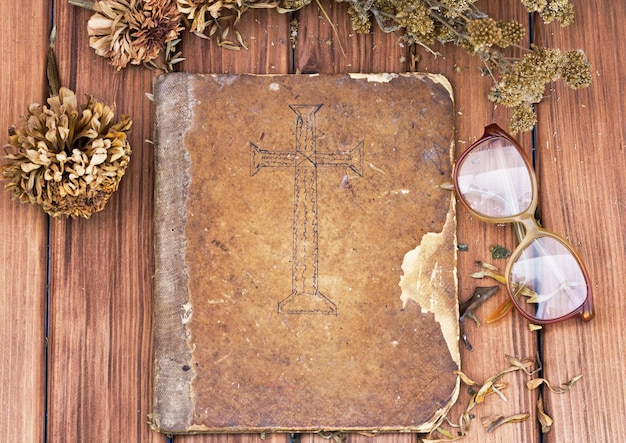 Old bible book with glasses on the table