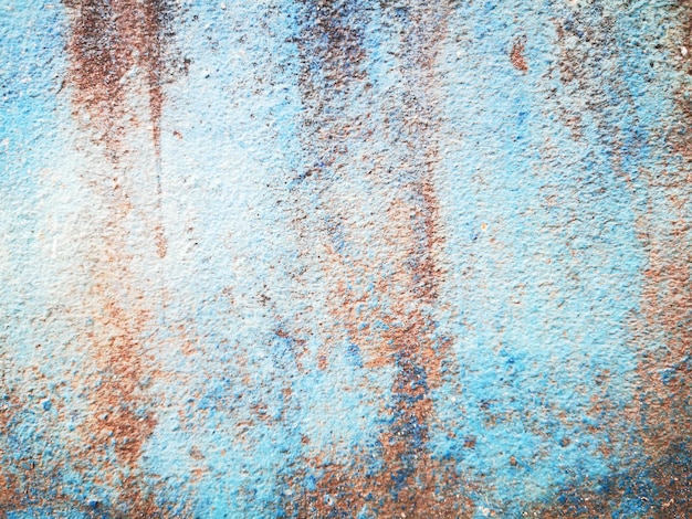 Old blue concrete wall with stains.