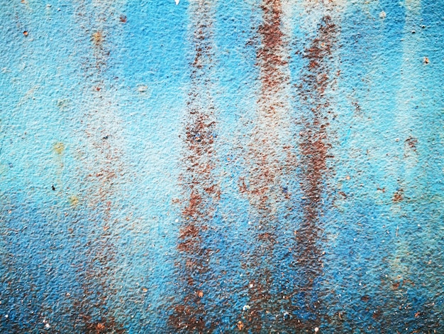 Old blue concrete wall with stains.