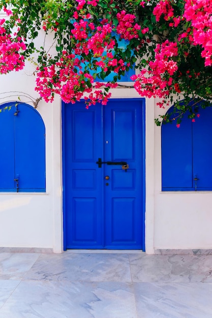 Old blue door and pink flowers traditional Greek architecture Santorini island Greece