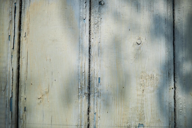 old blue door with cracked paint closeup Old cracked paint texture on wood material background