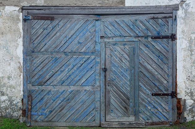 Old blue stripped wooden barn gate Protect property and privacy Front view