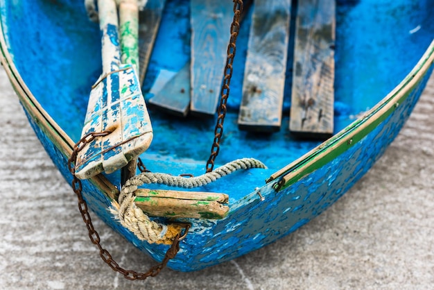 Old blue wooden shabby fishing boat detail