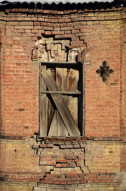 Old boarded window in brick wall