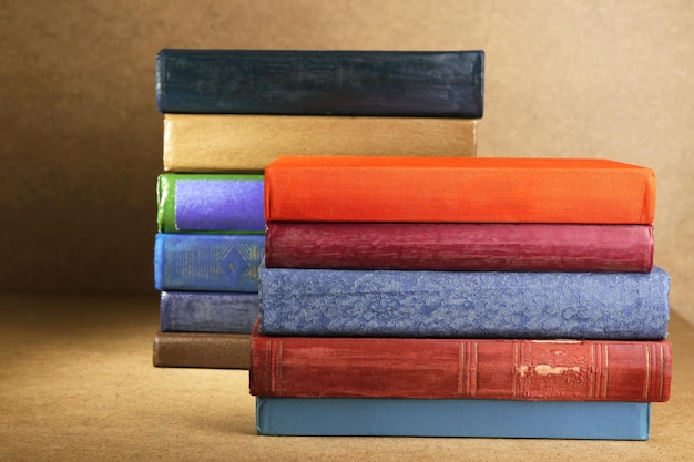 Old books on shelf closeup on wooden background