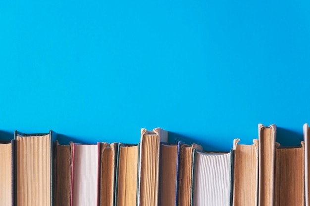 old books on a shelf with a blue background