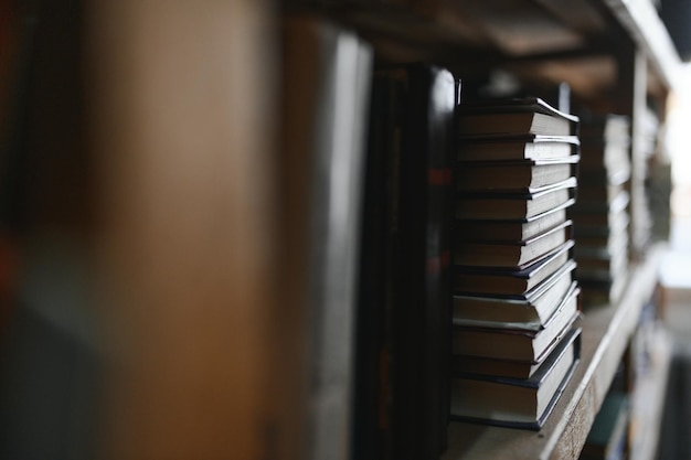 Photo old books on shelves in archive blurred image library