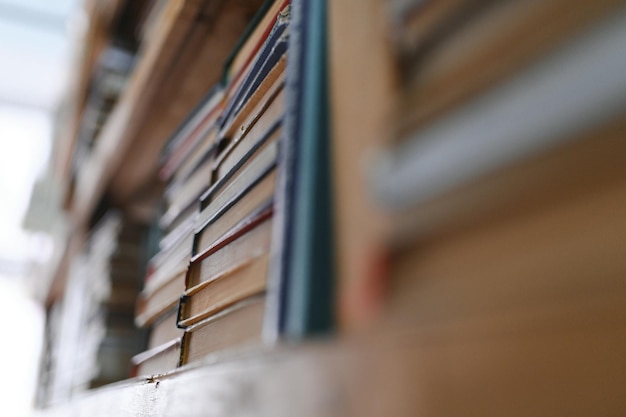 Old books on shelves in archive blurred image library