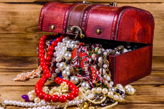 Old box of red wood full of the jewelry Treasure chest