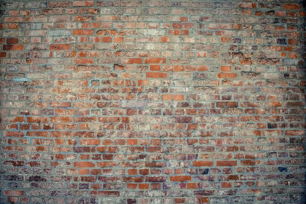 Old brick wall Brickwork from an old brick in a rustic style The structure and pattern of the destroyed stone wall Copy space