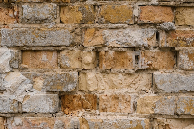 Old brick wall made of destroyed bricks