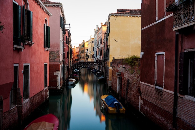 The old bridge made with wooden on the typical canal in Venice