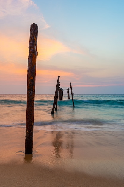 Old and broken wooden bridge at sea