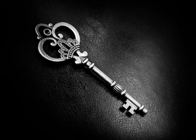 Old bronze key on a dark background