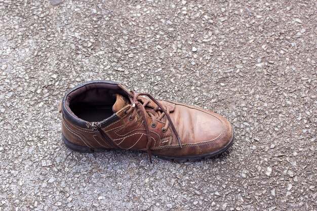 Old brown leather shoes on cement floor