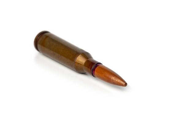 Old bullet for an automatic rifle 545 on a white background Selective focus