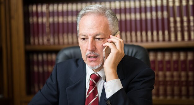 Old business man talking on phone