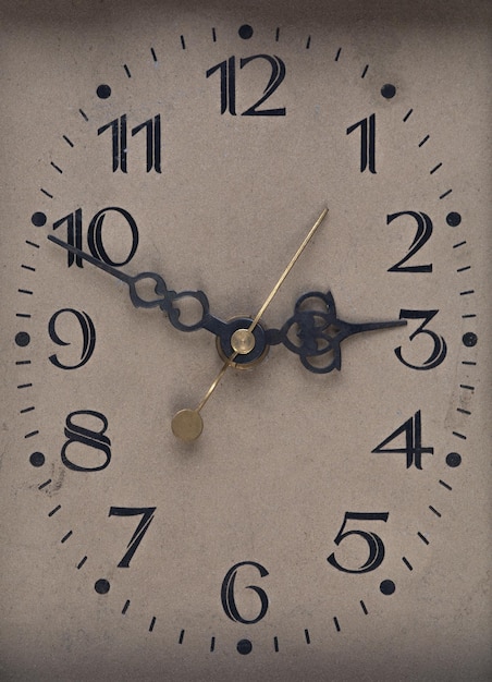 old cardboard clock face with arrows