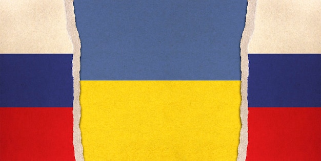 Old cardboard with Russian and Ukraine flag background