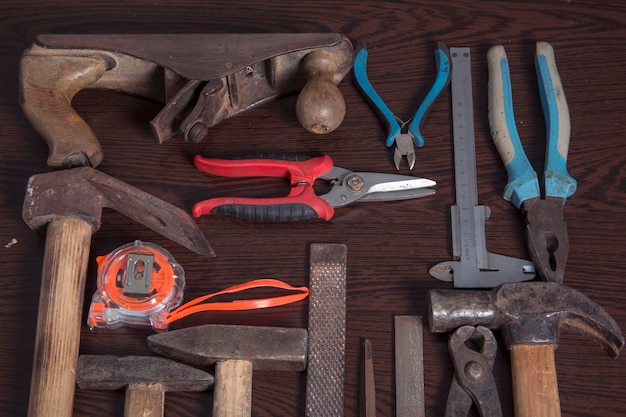 Old carpentry work tools on a brown wooden table background