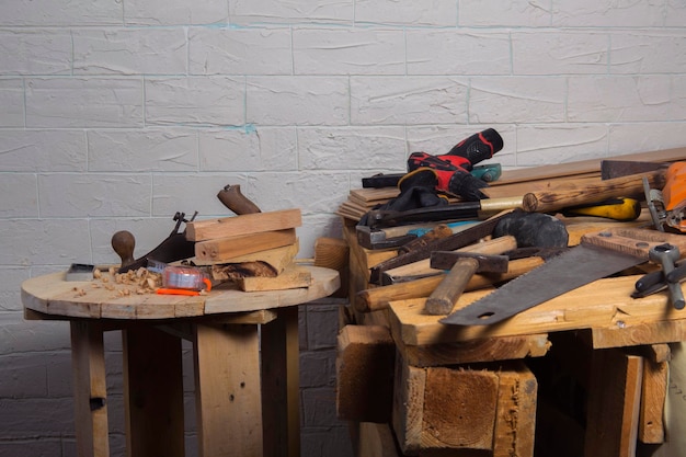 Old carpentry work tools on a wooden table background