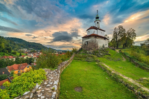 An old church on the hill with a dramatic sky in the background