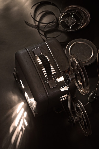 Old cinema projector and cassettes in the dark