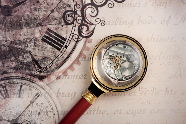 Old clock and loupe Vintage background time