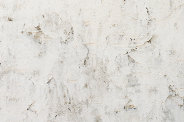 Old concrete wall is painted with white paint, background