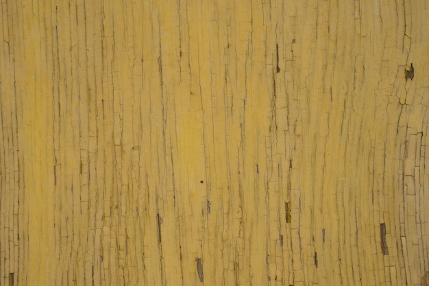 Old cracked wooden surface painted yellow