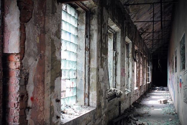 Old destroyed hallway with shabby walls and windows