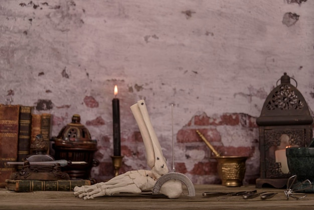 Old doctor's desk still life of instruments and bone parts typical of a doctor of the time