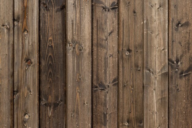 Old dry weathered brownish gray wooden planks board surface full frame background and texture