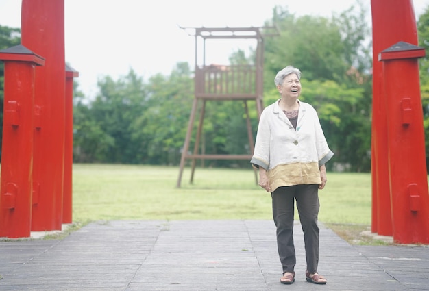 Old elderly elder senior woman resting walking in garden