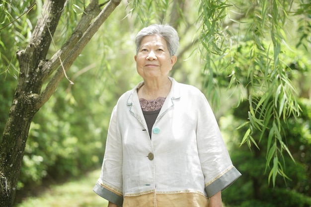 Old elderly elder senior woman resting walking in garden