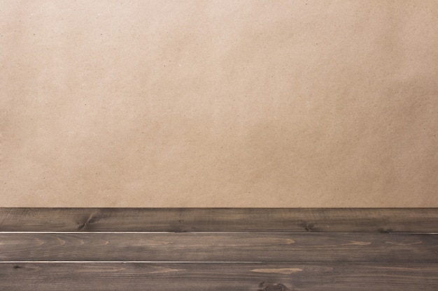 Old empty rustic grunge wooden table top against a blurred brown background with copyspace