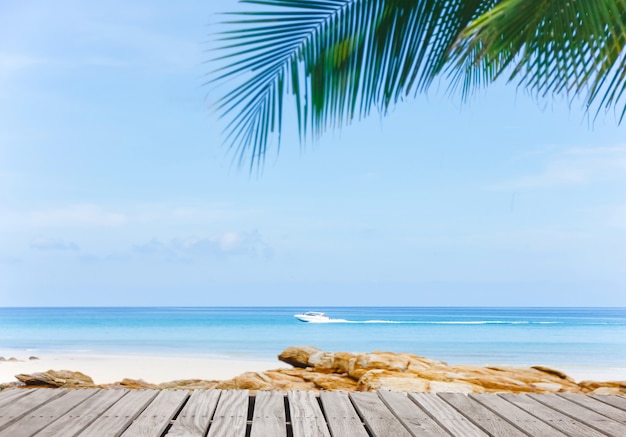 Old empty wooden pier perspective with sandy beach.Sand beach and Beautiful sea background in summer.