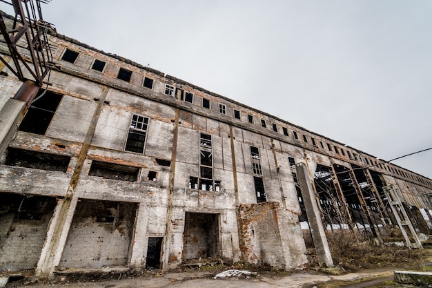 Old factory ruin and broken windows. Industrial building for demolition.