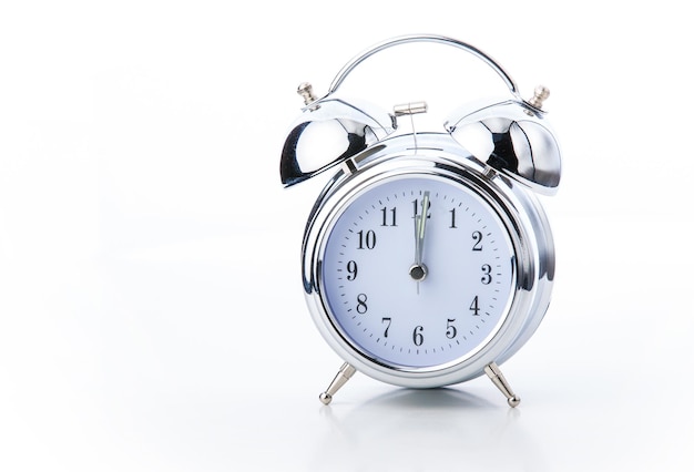 Old fashioned alarm clock on white backgrounds