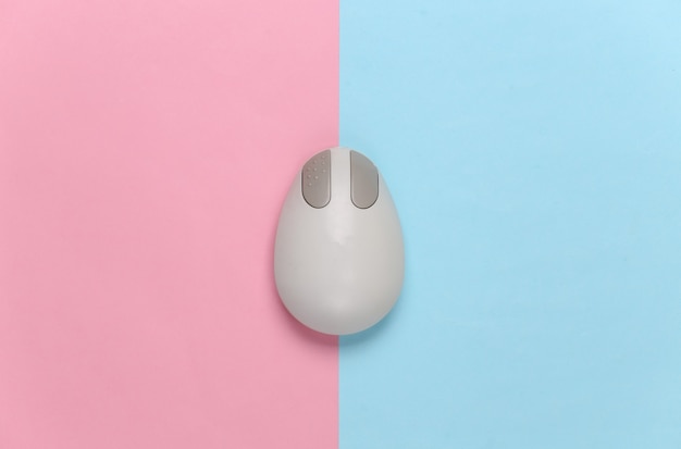 Old-fashioned retro pc mouse on pink blue