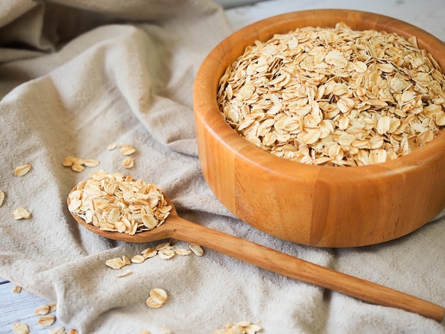 Old fashioned rolled oats in wooden bowl