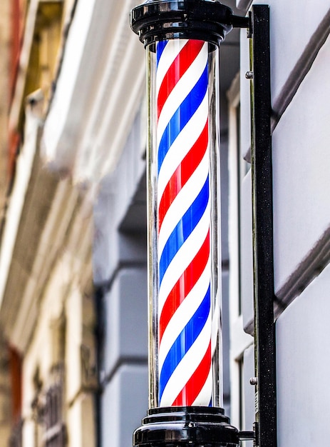 Old fashioned vintage barber shop pole. A classic barber logo. Bearded man. Barber shop pole. Logo of the barbershop, symbol. Barbershop pole, retro.