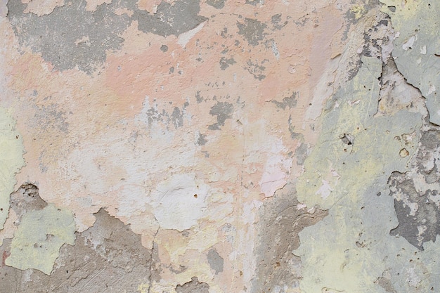 Old flaky wall with destroyed plaster Renovation of old house Industrial style design wall background Grunge cracked concrete wall with old paint Shabby peeling old background